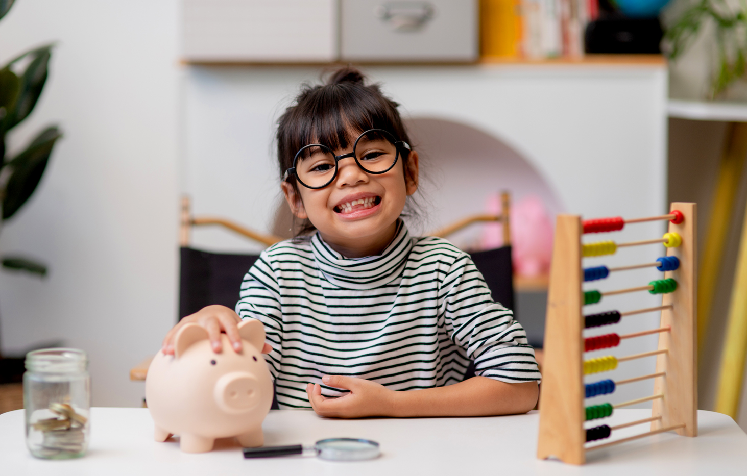 Portrait of cheerful multi ethnic business couple wearing suit and looking at camera with lot of copy space on right side